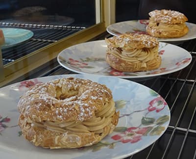 Gateau "Paris-brest" sur assiette fleurie du restaurant "Les Délices du Cotentin" à Sainte mère église.